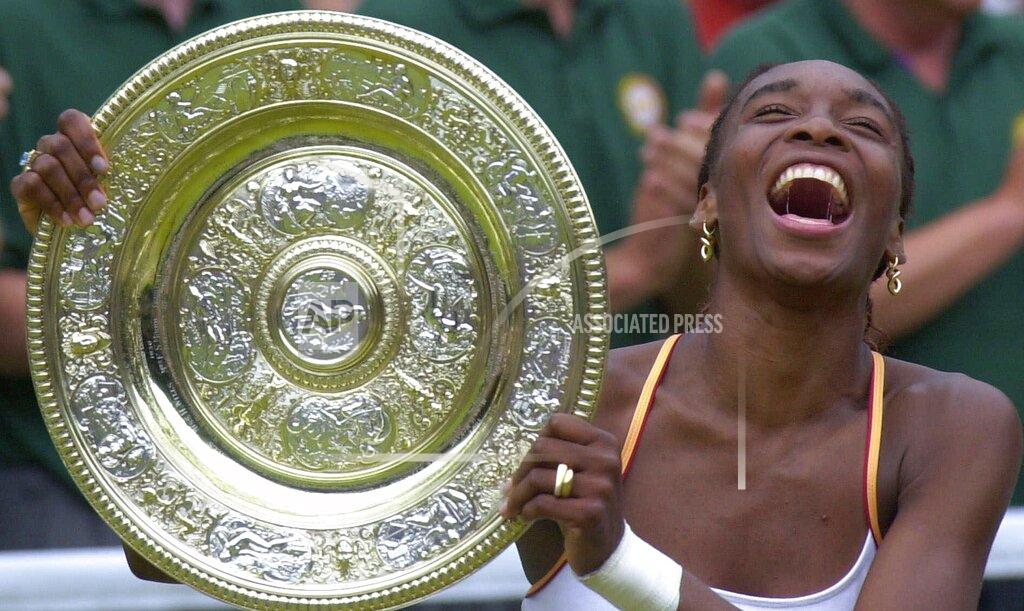 Adam Butler FILE - In this July 8, 2000, file photo, U.S. tennis player Venus Williams laughs as she holds the women's singles trophy on Centre Court at Wimbledon. (AP Photo/Adam Butler, File)