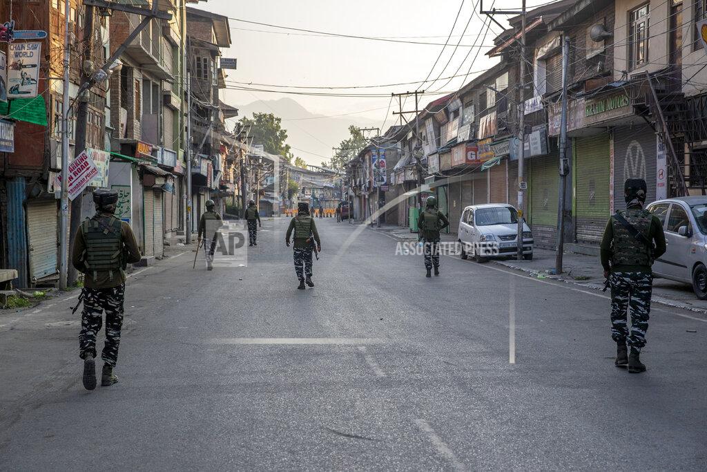 Dar Yasin Indian paramilitary soldiers patrol a deserted street on the first anniversary of India’s decision to revoke the disputed region’s semi-autonomy, in Srinagar, Indian controlled Kashmir, Wednesday, Aug. 5, 2020. Last year on Aug. 5, India’s Hindu-nationalist-led government of Prime Minister Narendra Modi stripped Jammu-Kashmir of its statehood and divided it into two federally governed territories. Late Tuesday, authorities lifted a curfew in Srinagar but said restrictions on public movement, transport and commercial activities would continue because of the coronavirus pandemic. (AP Photo/ Dar Yasin)