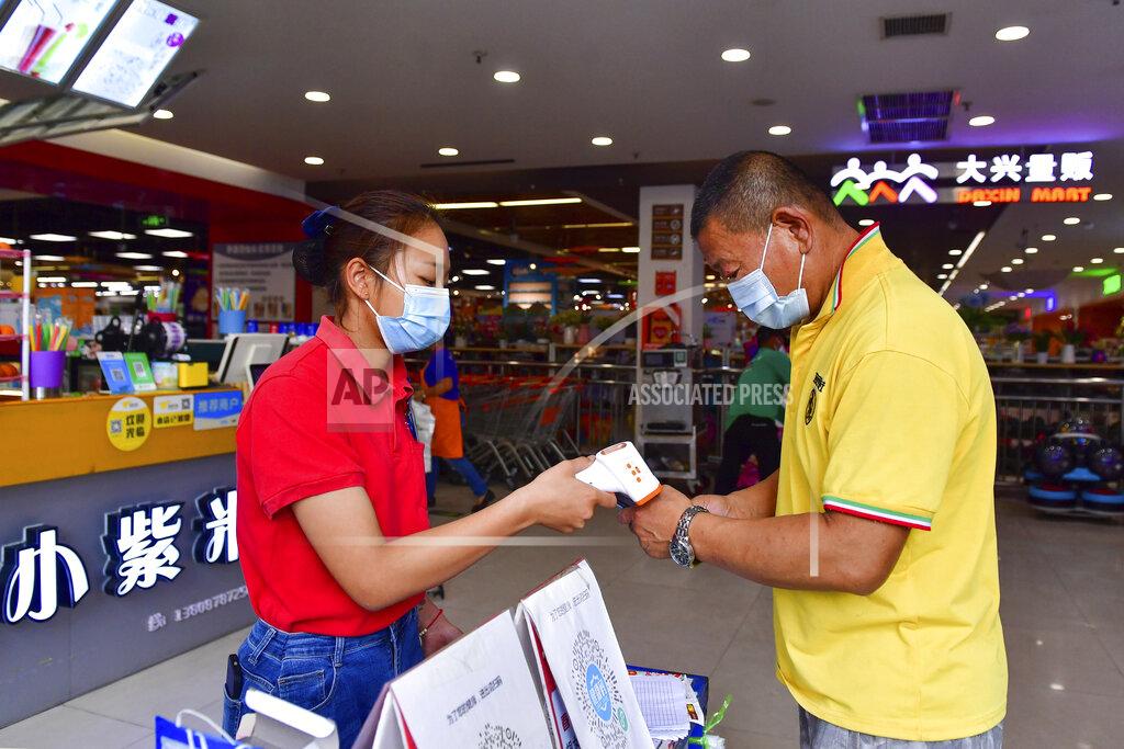 Chen Xinbo In this photo released by Xinhua News Agency, a resident goes through health screening to enter a supermarket in Ruili, southwestern China's Yunnan Province, on April 1, 2021. COVID-19 cases in the southwestern Chinese city of Ruili bordering on Myanmar have now topped 100 on Monday, April 5, 2021. That comes as authorities have launched an aggressive campaign to vaccinate all 300,000 residents of the city, whose outbreak is something of an anomaly in a country that has all-but eliminated local transmission of the virus.(Chen Xinbo/Xinhua via AP)