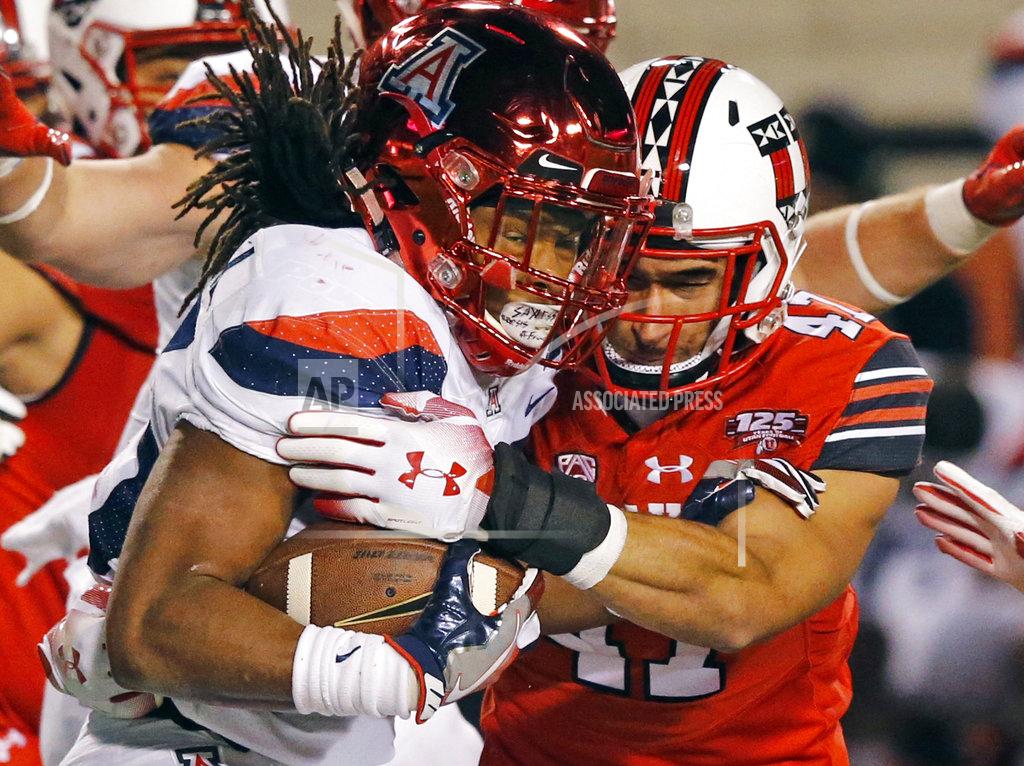 Rick Bowmer Arizona running back Gary Brightwell, left, is tackled by Utah defensive end Caleb Repp, right, in the second half during an NCAA college football game Friday, Oct. 12, 2018, in Salt Lake City. (AP Photo/Rick Bowmer)