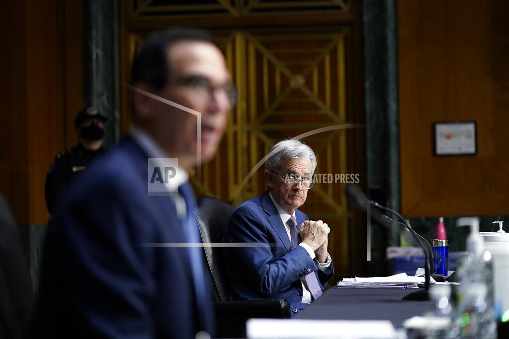 Susan Walsh Chairman of the Federal Reserve Jerome Powell listens as Treasury Secretary Steven Mnuchin testifies during a Senate Banking Committee hearing on 'The Quarterly CARES Act Report to Congress' on Capitol Hill in Washington, Tuesday, Dec. 1, 2020. (AP Photo/Susan Walsh, Pool)