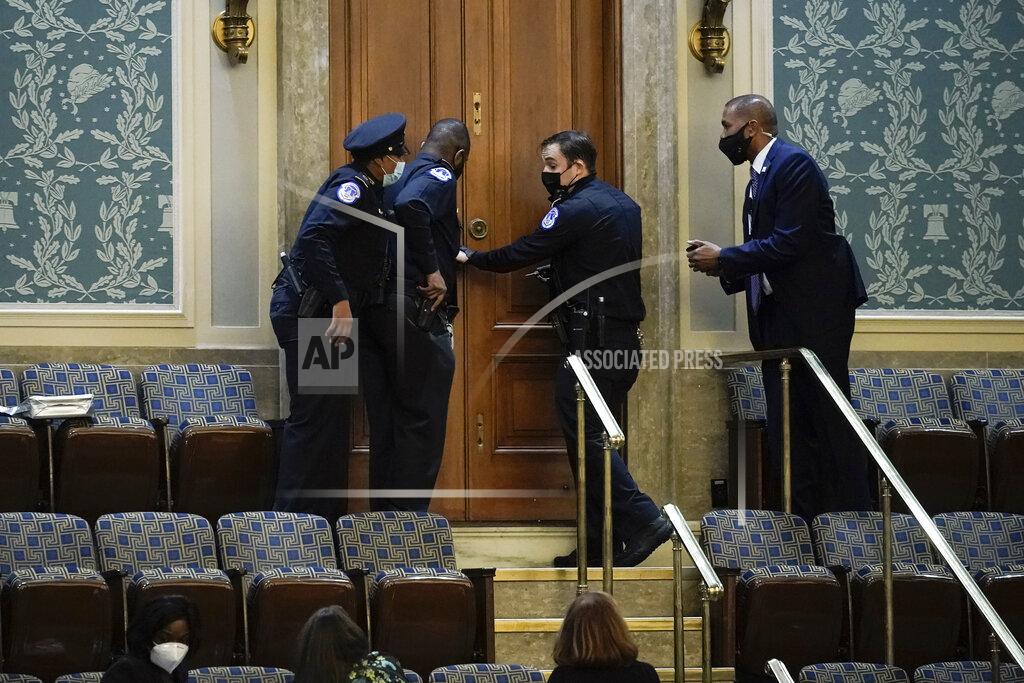 FILE - In this Jan. 6, 2021, file photo U.S. Capitol Police secure a door as rioters try to break into the House Chamber at the U.S. Capitol in Washington. (AP Photo/J. Scott Applewhite, File)
