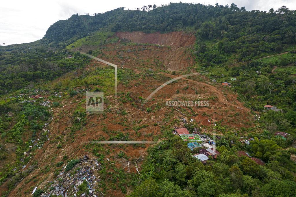 Rodrigo Abd A bird's eye view of the Honduran hilltop community La Reina, seven months after it was buried by a mudslide triggered by the November 2020 Hurricanes Eta and Iota, Tuesday, June 29, 2021. To rebuild their houses and replant their crops, the villagers needed land -- much of which is in the hands of drug traffickers. (AP Photo/Rodrigo Abd)