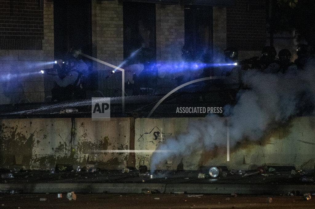 Carlos Gonzalez Minneapolis police at the 3rd Precinct looks out from a building Thursday night, May 28, 2020, in Minneapolis during protests over the Monday death of George Floyd in police custody. (Carlos Gonzalez/Star Tribune via AP)