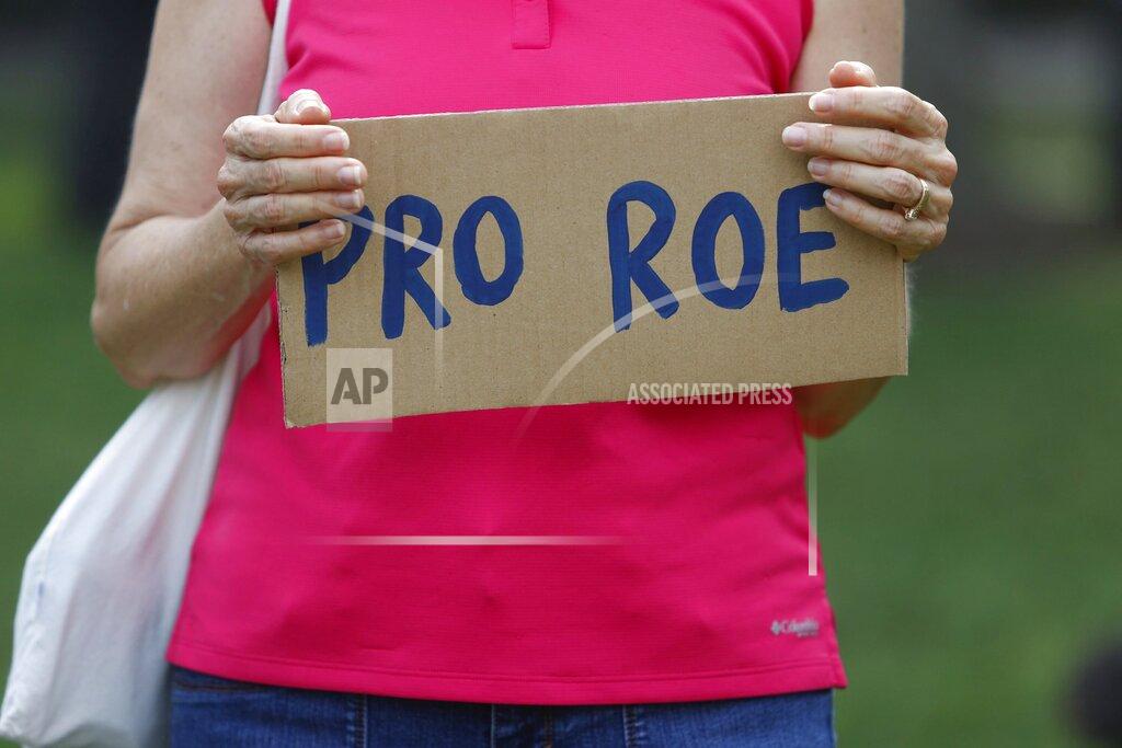 Jefferee Woo Protesters display their signs on Friday, June 24, 2022, at North Straub Park in St. Petersburg, Fla. The Supreme Court on Friday stripped away women’s constitutional protections for abortion, a fundamental and deeply personal change for Americans' lives after nearly a half-century under Roe v. Wade. The court’s overturning of the landmark court ruling is likely to lead to abortion bans in roughly half the states. (Jefferee Woo/Tampa Bay Times via AP)