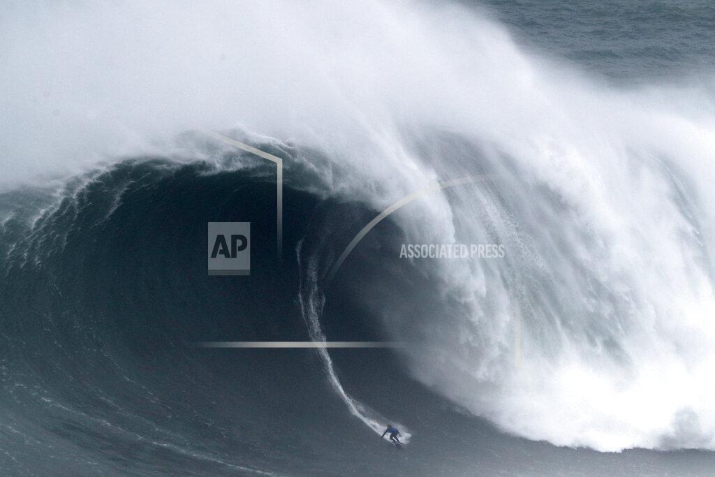 Armando Franca Kai Lenny from Hawaii rides a wave during the Nazare Tow Surfing Challenge at Praia do Norte or North Beach in Nazare, Portugal, Tuesday, Feb. 11, 2020. (AP Photo/Armando Franca)