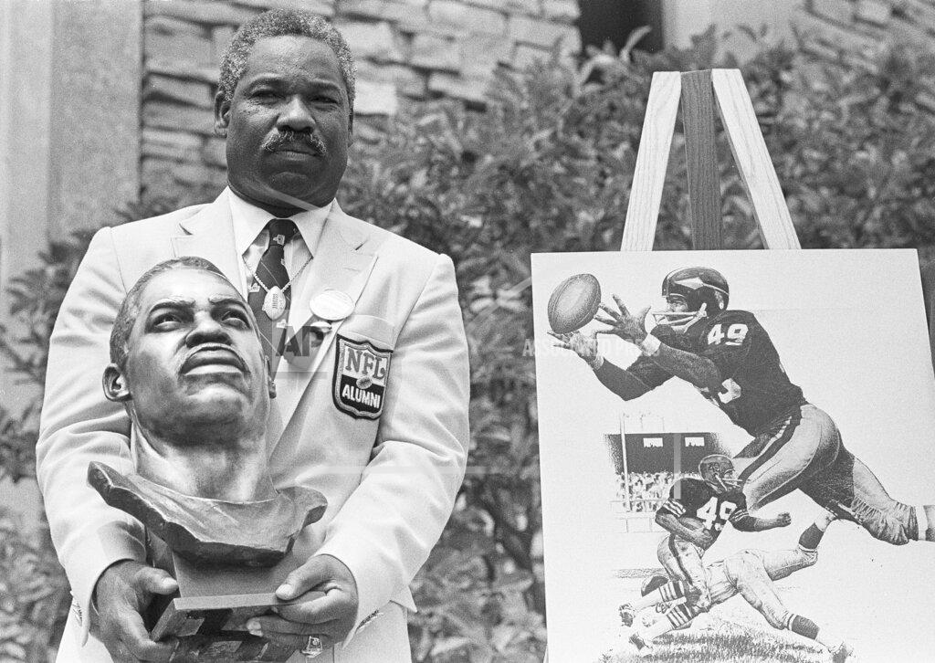 Gus Chan FILE - In this July 30, 1983, file photo, former Cleveland Browns and Washington Redskins halfback and wide receiver Bobby Mitchell poses with his bronze bust after being inducted into the Pro Football Hall of Fame in ceremonies in Canton, Ohio. The Washington Redskins will retire the jersey of Mitchell and rename the lower level of FedEx Field for him, replacing former owner George Preston Marshall. The team, which is being pressured to change its name during the ongoing national reckoning over racism, said Saturday, June 20, 2020, that the No. 49 will become on the second in the franchise's 88-year history to be retired. (AP Photo/Gus Chan, File)