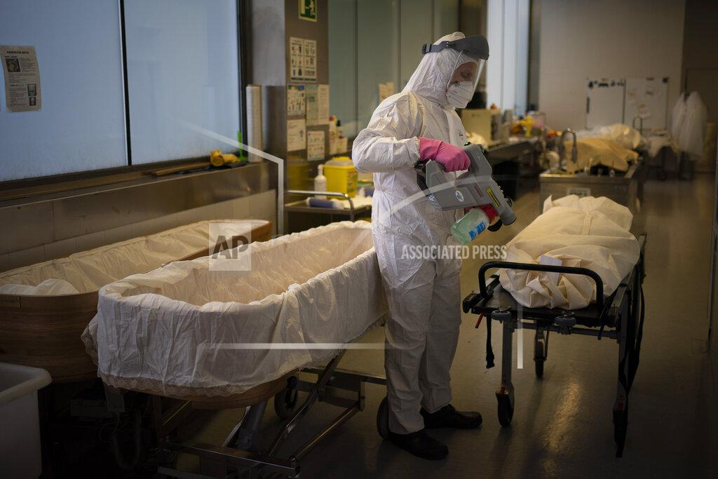 Emilio Morenatti A mortuary worker disinfests the body of a person who died of COVID-19 ahead of a funeral at Memora mortuary in Girona, Spain, Thursday, Feb. 4, 2021. Spain's health ministry said Wednesday that the southern European nation has surpassed 60,000 fatalities from COVID-19. The ministry reported 565 new deaths in the previous 24 hours, taking the total death count since the start of pandemic to 60,370. (AP Photo/Emilio Morenatti)