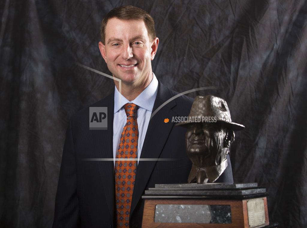 Yi-Chin Lee Clemson coach Dabo Swinney poses for a photograph with the Paul "Bear" Bryant Coach of the Year Award, before the ceremony Wednesday, Jan. 9, 2019, in Houston. (Yi-Chin Lee/Houston Chronicle via AP)
