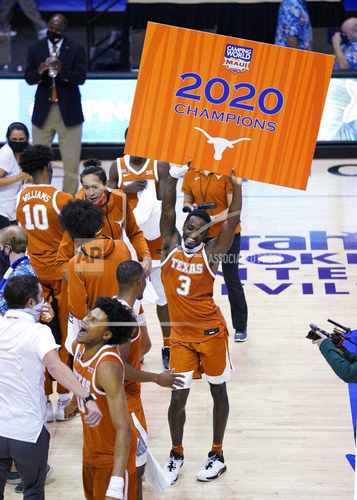 Kathy Kmonicek Texas guard Courtney Ramey (3) dances and holds a poster after the team's win over North Carolina in an NCAA college basketball game for the championship of the Maui Invitational, Wednesday, Dec. 2, 2020, in Asheville, N.C. (AP Photo/Kathy Kmonicek)