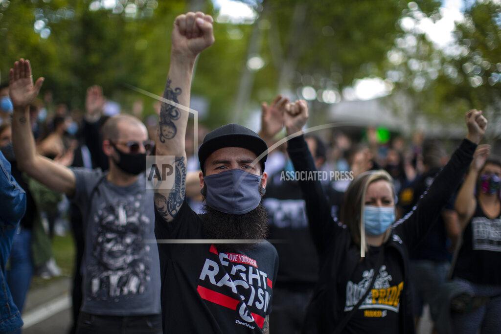 Manu Fernandez People take part in a protest to demand more resources for public health system and against social inequality in the southern neighbourhood of Vallecas in Madrid, Spain, Sunday, Sept. 27, 2020. Residents in a lockdown district of Madrid protested outside the Madrid Regional Government that local health services needed to be reinforced during the ongoing COVID-19 outbreak. (AP Photo/Manu Fernandez)