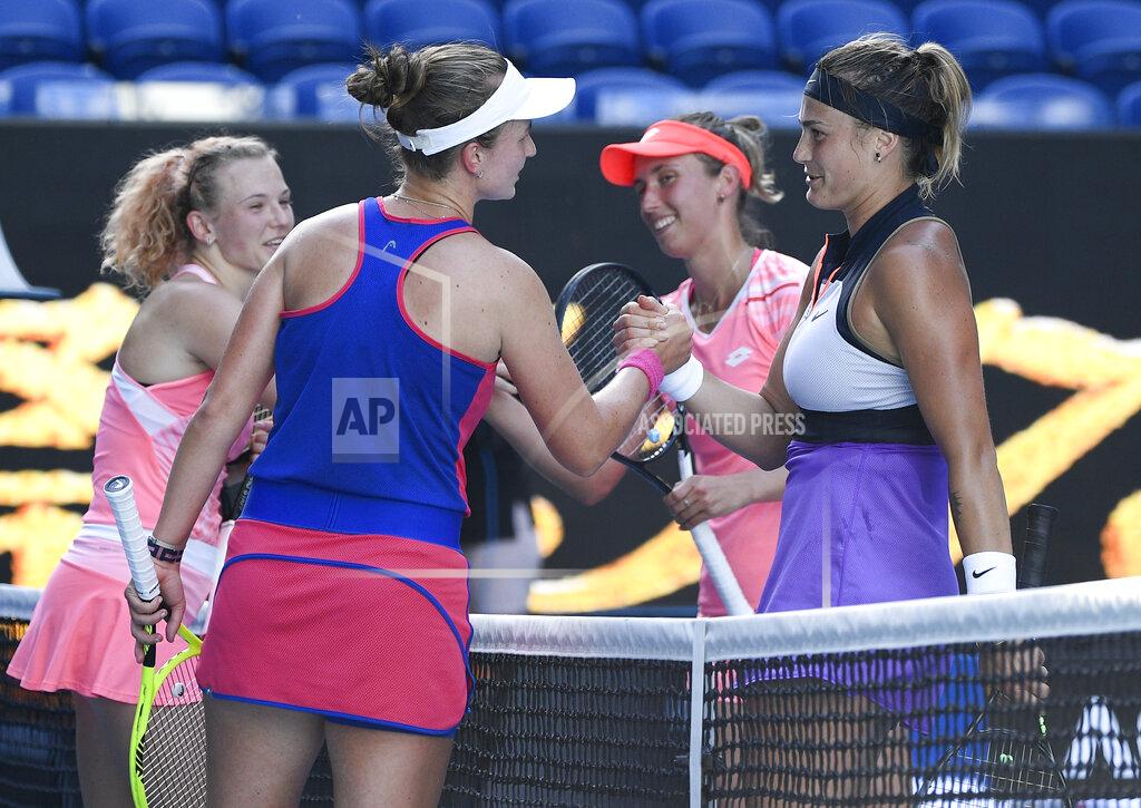 Andy Brownbill Belgium's Elise Mertens, second right, and Aryna Sabalenka, right, of Belarus are congratulated by Barbora Krejcikova and Katerina Siniakova, left, of the Czech Republic after winning the women's doubles final at the Australian Open tennis championship in Melbourne, Australia, Friday, Feb. 19, 2021.(AP Photo/Andy Brownbill)