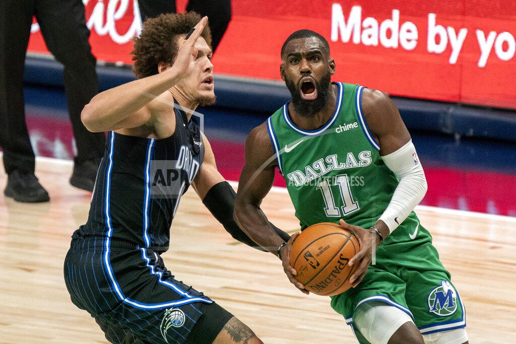 Jeffrey Mcwhorter Dallas Mavericks guard Tim Hardaway Jr. (11) drives past Orlando Magic forward Aaron Gordon during the second half of an NBA basketball game, Saturday, Jan. 9, 2021, in Dallas. (AP Photo/Jeffrey McWhorter)
