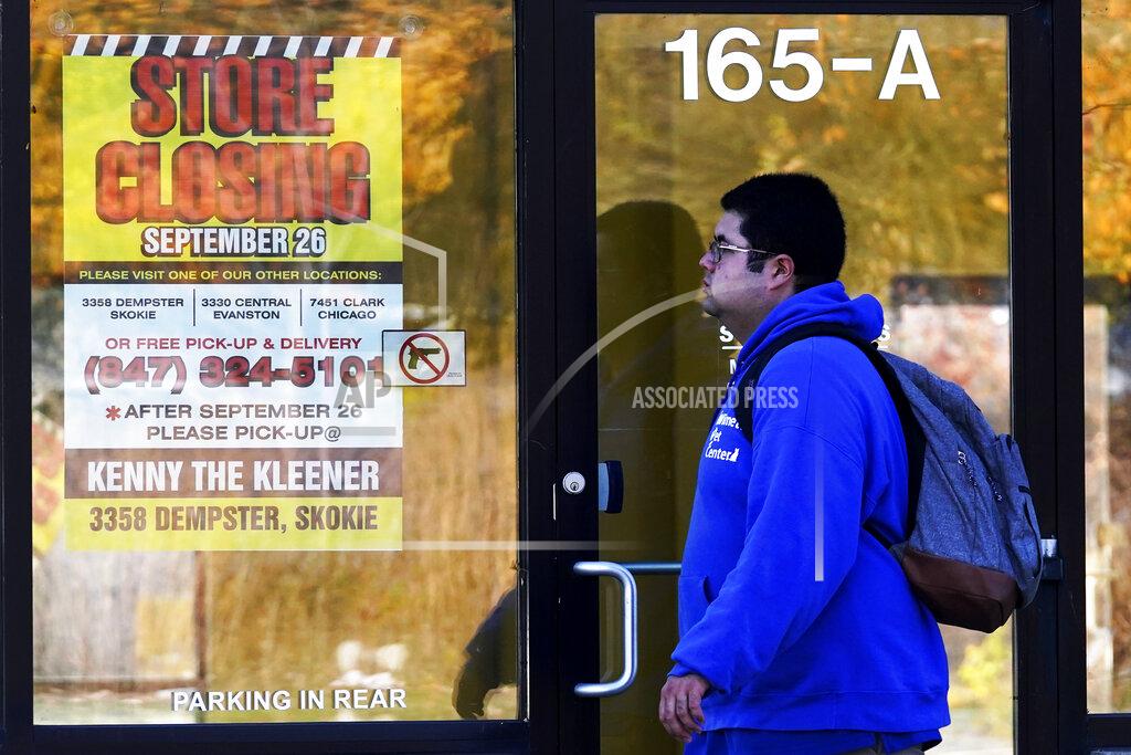 Nam Y. Huh FILE - In this Friday, Nov. 6, 2020, file photo, a man walks past a closed store in Wilmette, Ill., amid the coronavirus pandemic. Responses to the coronavirus pandemic and police brutality dominated legislative sessions in 2020 and led to many new laws that will take effect in the new year. (AP Photo/Nam Y. Huh, File)