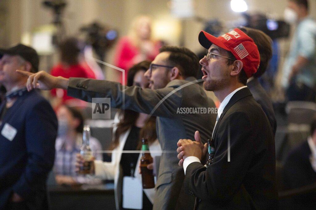 Branden Camp Supporters of Sen. Kelly Loeffler, R-Ga., react to Democratic presidential candidate former Vice President Joe Biden's numbers in the suburb of Cobb County, Ga., during a watch party at the Grand Hyatt Hotel on Election Night, Tuesday, Nov. 3, 2020, in Atlanta. (Branden Camp/Atlanta Journal-Constitution via AP)