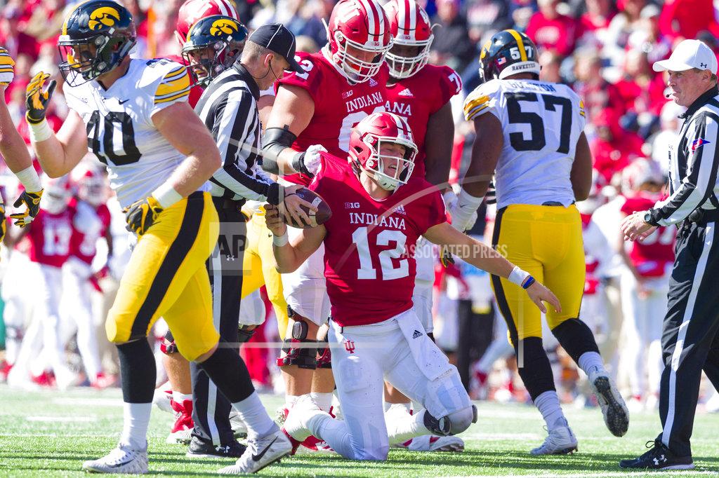 Doug Mcschooler Indiana quarterback Peyton Ramsey (12) is helped to his feet by his teammates after being sacked by the Iowa defense during the first half of an NCAA college football game Saturday, Oct. 13, 2018, in Bloomington, Ind. (AP Photo/Doug McSchooler)