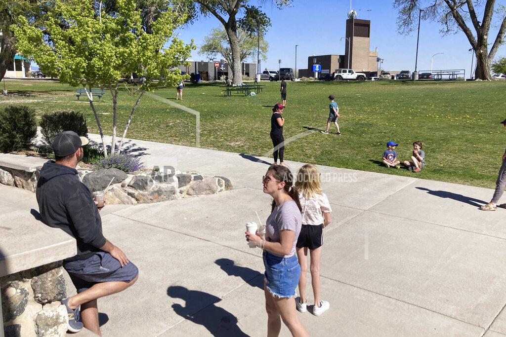 Morgan Lee Families flocked to a public park in downtown Los Alamos, N.M., on Thursday, May 12, 2022, during a weeklong public school closure because of nearby wildfire. The blaze crept has been creeping closer to the mesa-top city and companion Los Alamos National Laboratory that analyzes global threats of disease, warfare and natural disasters. Scientists at Los Alamos are using supercomputers and ingenuity to improve wildfire forecasting and forest management amid drought and climate change in the American West. (AP Photo/Morgan Lee)