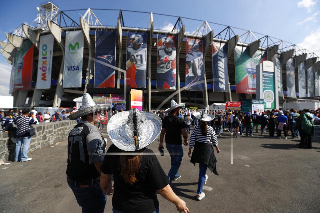 Eduardo Verdugo FILE - In this Nov. 19, 2017, file photo, fans arrive at Azteca stadium before an NFL football game between the Oakland Raiders and the New England Patriots in Mexico City. The NFL is moving its five games scheduled for London and Mexico City this season back to U.S. stadiums because of the coronavirus pandemic. All five regular-season games will now be played at the stadiums of the host teams. (AP Photo/Eduardo Verdugo, File)