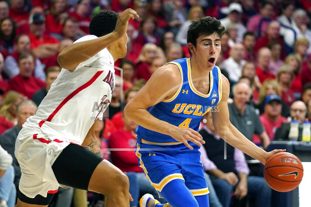Rick Scuteri UCLA guard Jaime Jaquez Jr. (4) shields the ball from Arizona forward Ira Lee during the first half of an NCAA college basketball game Saturday, Feb. 8, 2020, in Tucson, Ariz. (AP Photo/Rick Scuteri)