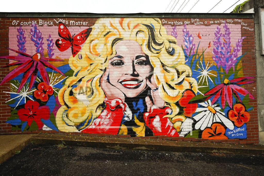 Mark Humphrey A mural of Dolly Parton is seen outside The 5 Spot, a music club in Nashville, Tenn., Friday, Aug. 21, 2020. Artist Kim Radford said Dolly fans from around the world have contacted her about the mural, which contains a quote from Parton about her support for the Black Lives Matter movement. (AP Photo/Mark Humphrey)