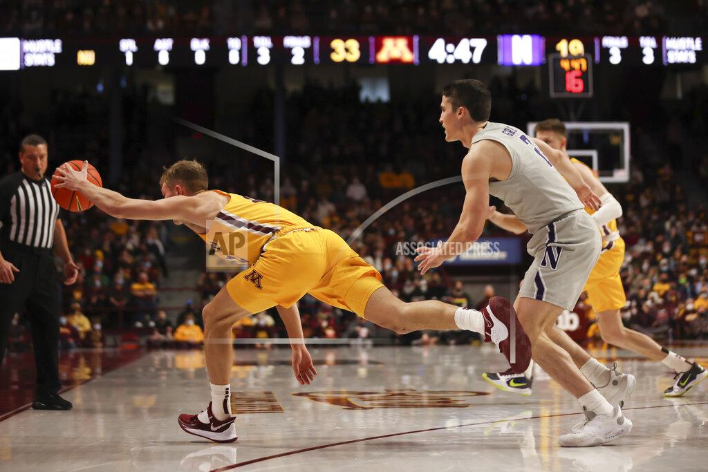 Stacy Bengs Minnesota guard Luke Loewe (12) reaches to keep the ball in bounds against Northwestern guard Ryan Greer (2) during the first half of an NCAA college basketball game Saturday, Feb. 19, 2022, in Minneapolis. (AP Photo/Stacy Bengs)