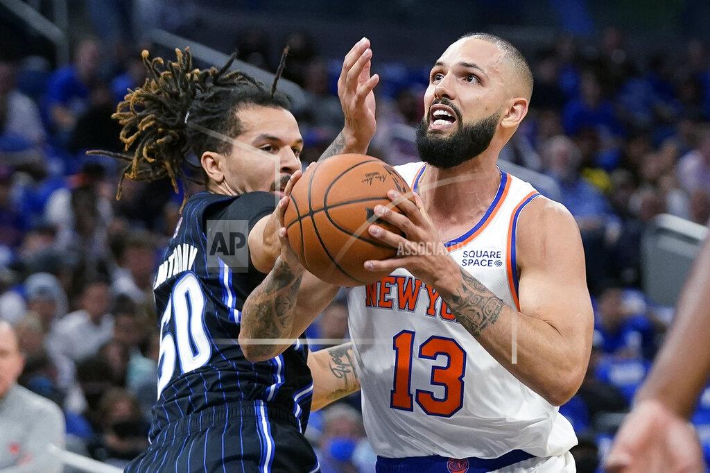 John Raoux New York Knicks' Evan Fournier (13) goes up for a shot against Orlando Magic's Cole Anthony, left, during the first half of an NBA basketball game Friday, Oct. 22, 2021, in Orlando, Fla. (AP Photo/John Raoux)