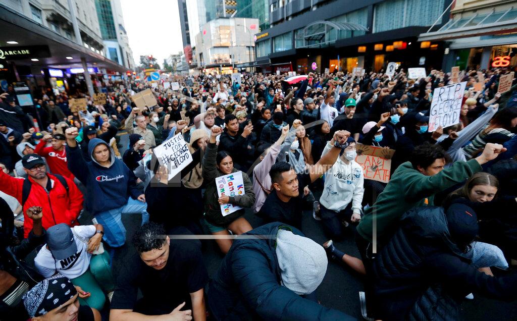 Dean Purcell Demonstrators hold placards during a march in central Auckland, New Zealand, Monday, June 1. 2020, to protest the death of United States' George Floyd, a black man who died in police custody in Minneapolis on May 25. Floyd, who after a white police officer who is now charged with murder, Derek Chauvin, pressed his knee into Floyd's neck for several minutes even after he stopped moving and pleading for air. (Dean Purcell/New Zealand Herald via AP