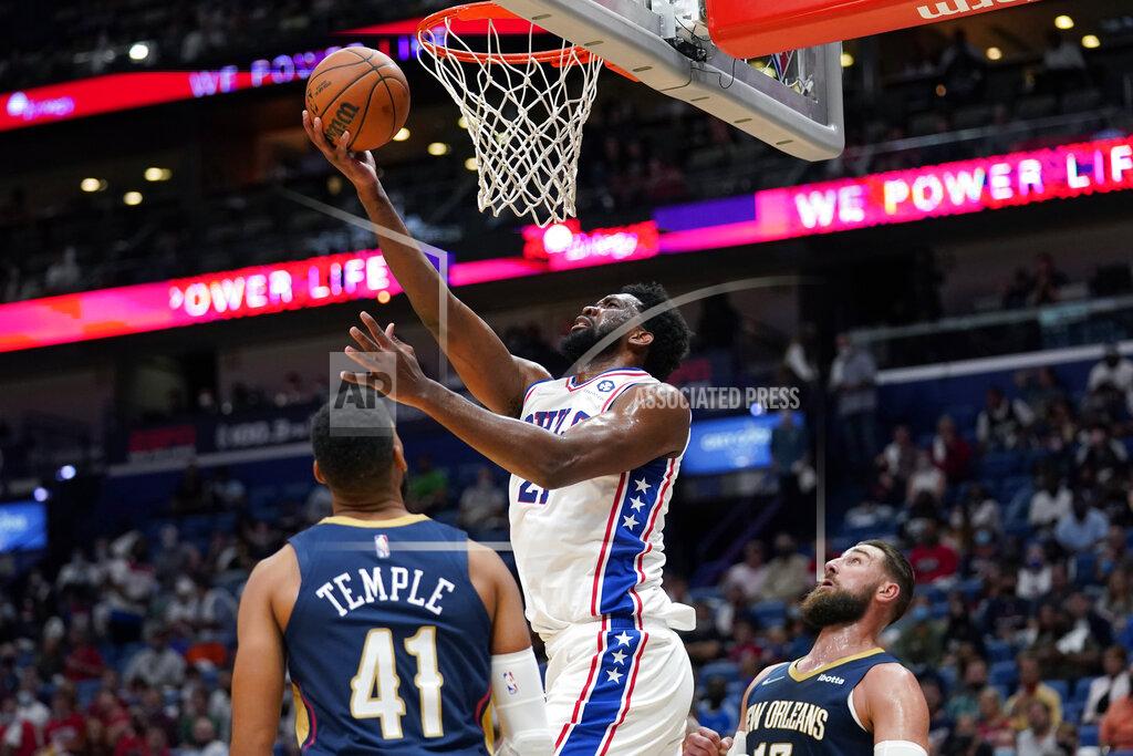 Gerald Herbert Philadelphia 76ers center Joel Embiid (21) goes to the basket over New Orleans Pelicans forward Garrett Temple (41) in the first half of an NBA basketball game in New Orleans, Wednesday, Oct. 20, 2021. (AP Photo/Gerald Herbert)
