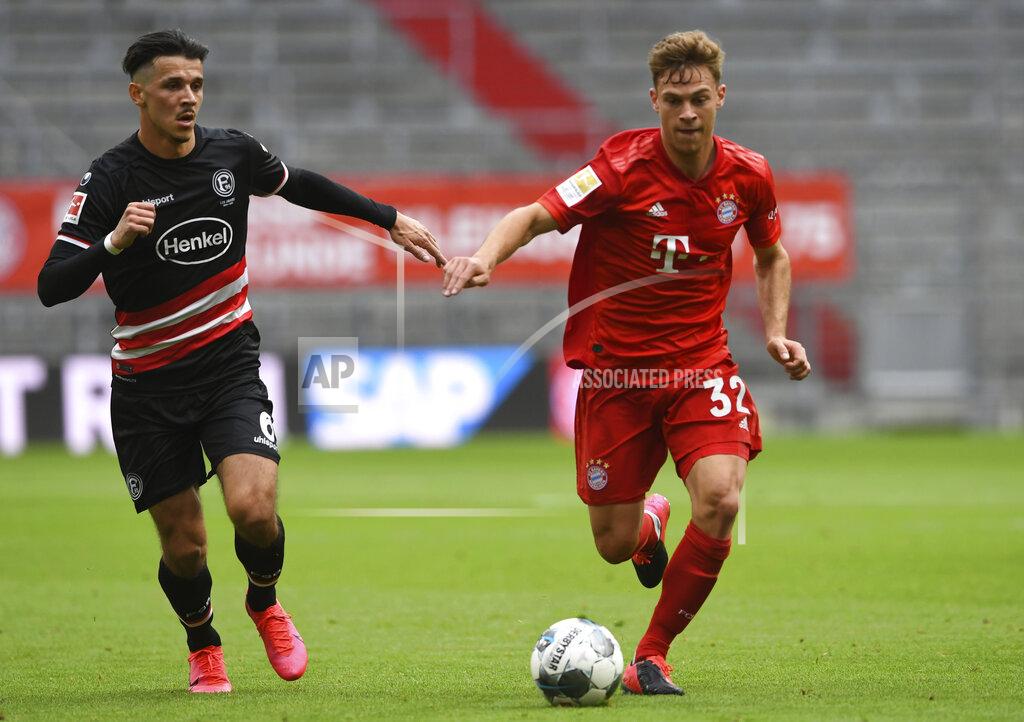 Christof Stache Duesseldorf's Alfredo Morales, left, and Bayern's Joshua Kimmich challenge for the ball during the German Bundesliga soccer match between FC Bayern Munich and Fortuna Duesseldorf in Munich, Germany, Saturday, May 30, 2020. Because of the coronavirus outbreak all soccer matches of the German Bundesliga take place without spectators. (Christof Stache/Pool via AP)