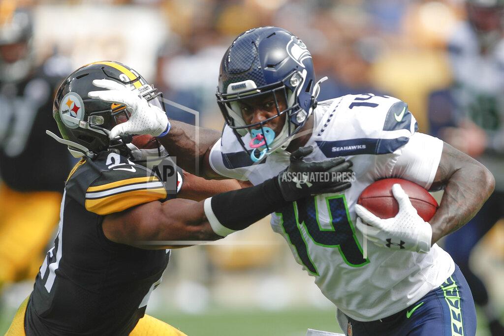 Don Wright Seattle Seahawks wide receiver John Ursua (15) stiff arms Pittsburgh Steelers free safety Sean Davis (21) after making a catch in the second half of an NFL football game, Sunday, Sept. 15, 2019, in Pittsburgh. (AP Photo/Don Wright)