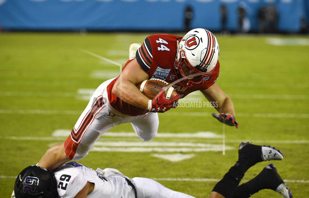 Denis Poroy Utah tight end Jake Jackson (44) jumps over Northwestern defensive back Greg Newsome II (29) as he scores a touchdown during the first half of the Holiday Bowl NCAA college football game Monday, Dec. 31, 2018, in San Diego. (AP Photo/Denis Poroy)