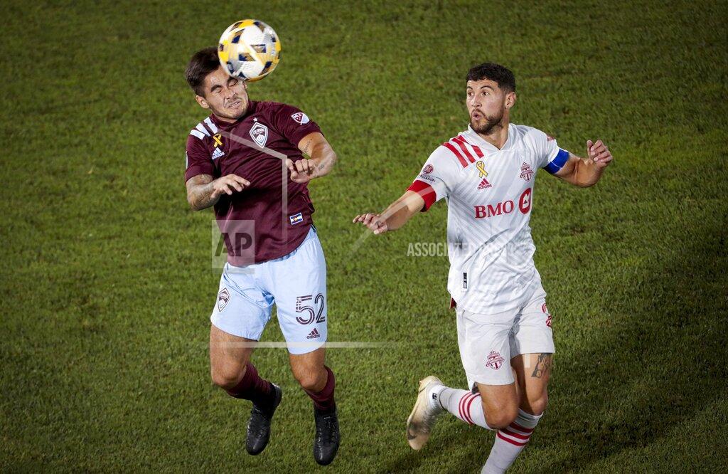 Joe Mahoney Colorado Rapids midfielder Braian Galvan (52) heads the ball away from Toronto FC defender Chris Mavinga (23) in the second half of an MLS soccer game in Denver, Saturday, Sept. 25, 2021. Toronto and Colorado tied, 0-0. (AP Photo/Joe Mahoney)