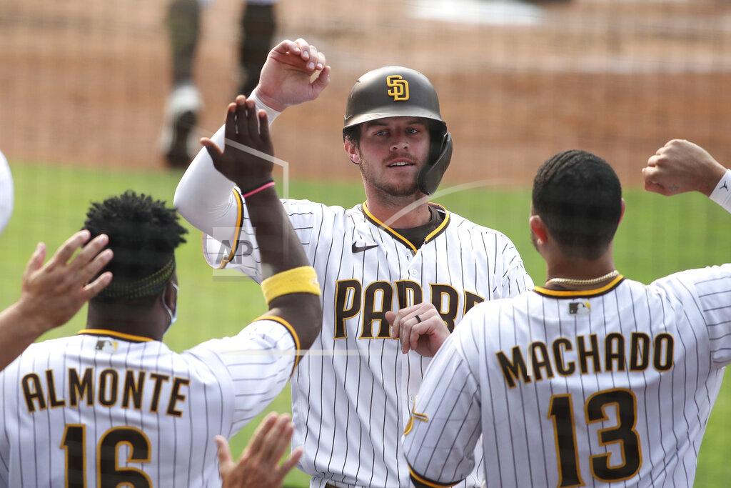 Derrick Tuskan FILE - In this Sept. 13, 2020 file photo, San Diego Padres Wil Myers is congratulated by teammates after hitting a solo home run against the San Francisco Giants' in the second inning of a baseball game in San Diego. Wil Myers is back. While Manny Machado and Fernando Tatis Jr. have grabbed most of the attention on the playoff-bound Padres, Myers' comeback performance has also been instrumental in returning San Diego to postseason play for the first time since 2006. Myers is hitting .291 with 14 homers and 38 RBIs in 52 games. (AP Photo/Derrick Tuskan, File)