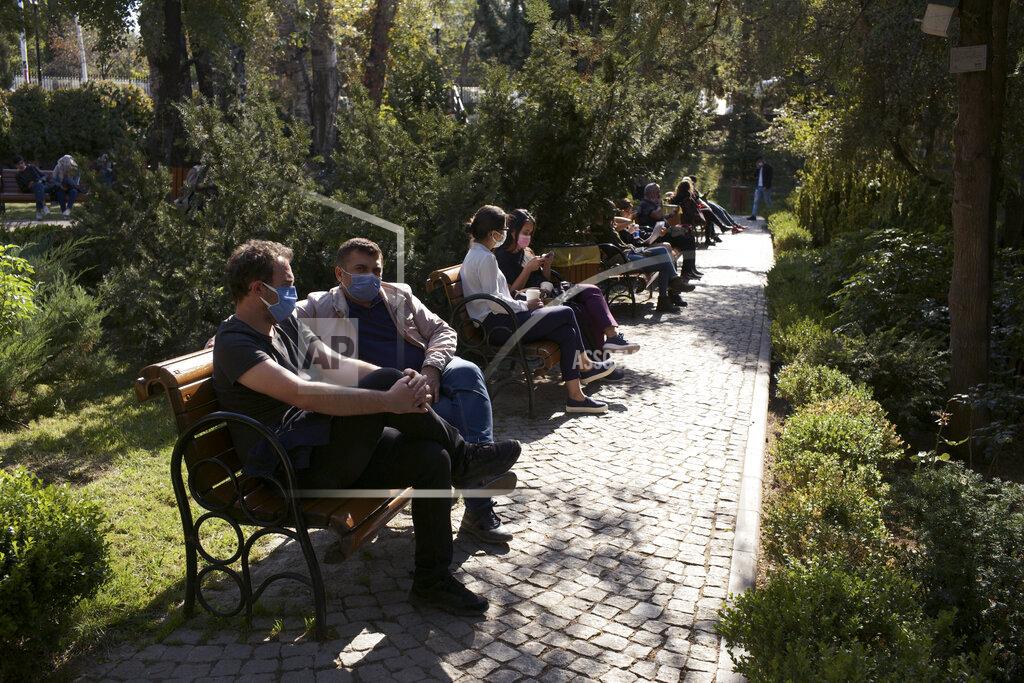 Burhan Ozbilici People wearing masks to help protect against the spread of coronavirus, sit in a public garden, in Ankara, Turkey, Friday, Oct. 23, 2020. Turkey's Health Minister Fahrettin Koca said Friday COVID-19 infections were on the rise across the country and 40 percent of cases were in Istanbul, Turkey's most populous city with more than 15 million people.(AP Photo/Burhan Ozbilici)