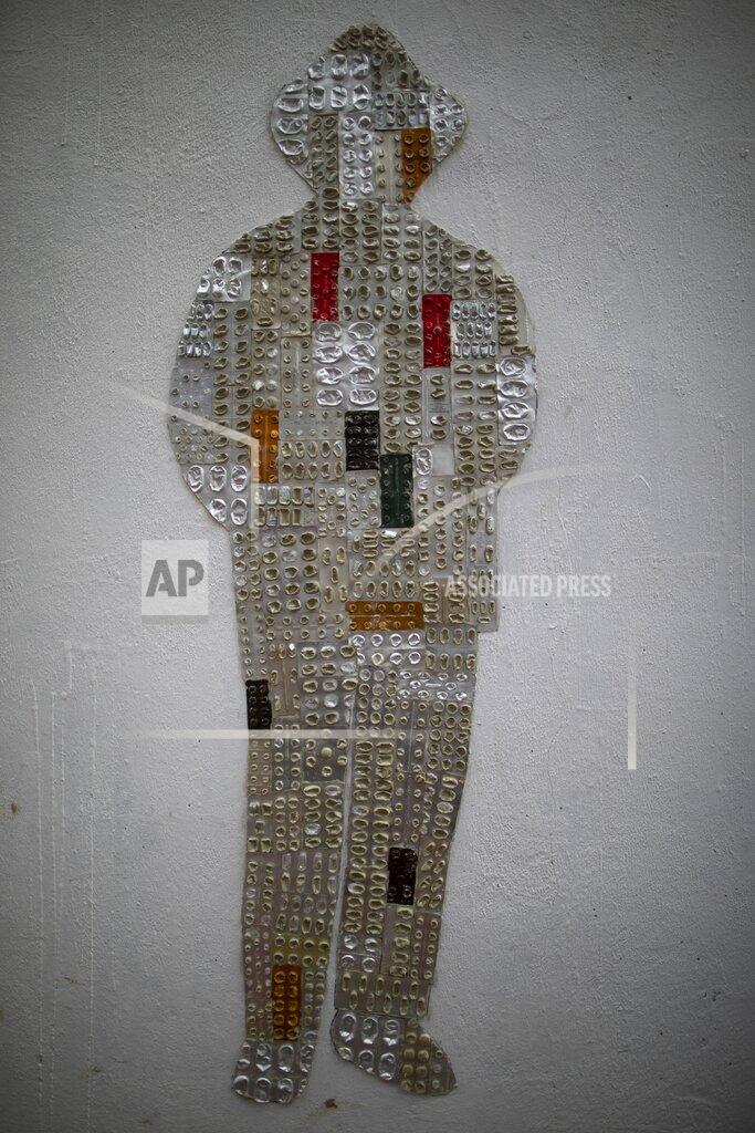 Ariana Cubillos A silhouette with recycled pill packs that represents the late Venezuelan Dr. Jose Gregorio Hernandez, known as the "doctor of the poor, constructed by artist Susan Applewhite, is pictured on a wall in downtown Caracas, Venezuela, Saturday, April 24, 2021. Hernandez is set to be beatified by the Catholic church, a step towards sainthood, on April 30th in the Venezuelan capital. (AP Photo/Ariana Cubillos)