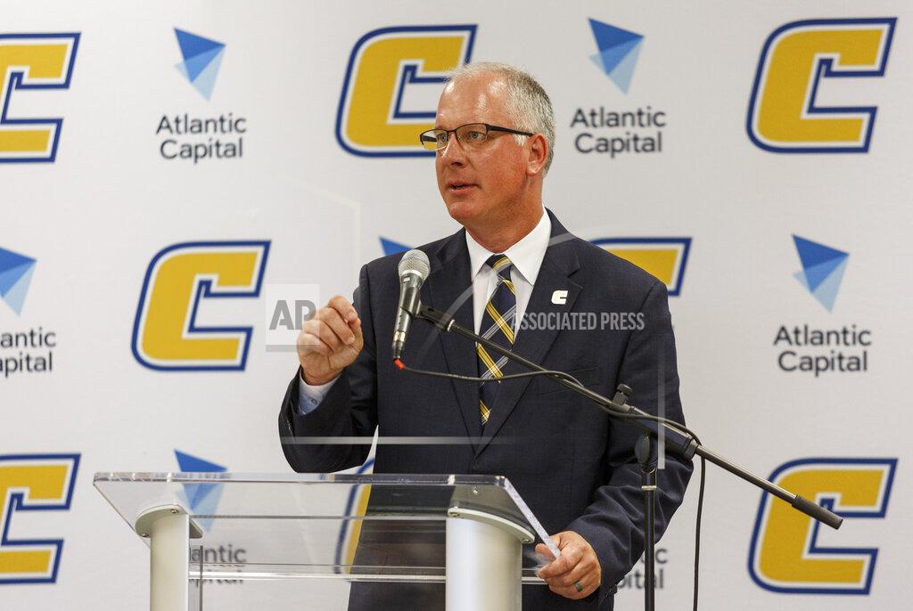 Doug Strickland FILE - In this Aug. 23, 2017, file photo, University of Tennessee at Chattanooga athletic director Mark Wharton speaks during a news conference in the University Center in Chattanooga, Tenn. When college sports teams finally return to action after this hiatus, they might not be traveling quite as far as they did for road games before this pandemic. Chattanooga announced last month that any 2020-21 away games that hadn’t already been scheduled must be played within 150 miles of its campus. Those teams also need to return to campus the day of the game to avoid any lodging costs. (Doug Strickland/Chattanooga Times Free Press via AP, File)