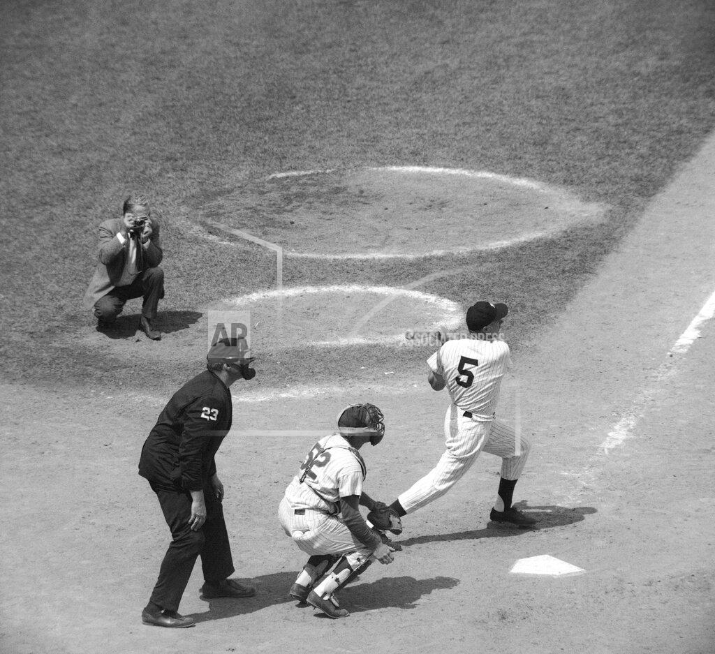 John Rooney FILE - Joe DiMaggio (5), former New York Yankees baseball great, hits a single in the New York Mets' Old Timers' Game at Shea Stadium in New York on July 31, 1971, as Joe Pignatano (52), a former Brooklyn Dodgers player, catches and umpire is Lee Weyer, bottom left, look on. Pignatano, who made his major league debut with the Dodgers in 1957 and later was a coach for the New York Mets, died Monday, May 23, 2022, in Naples, Fla. (AP Photo/John Rooney, File)