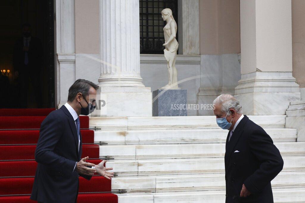 Yorgos Karahalis Greece's Prime Minister Kyriakos Mitsotakis, left, welcomes Britain's Prince Charles at Maximos Mansion in Athens, Thursday, March 25, 2021. Greece's celebrations for the bicentenary of the start of the nation's war of independence are culminating in a military parade and warplane flyby in Athens on Thursday, the country's Independence Day. (AP Photo/Yorgos Karahalis)
