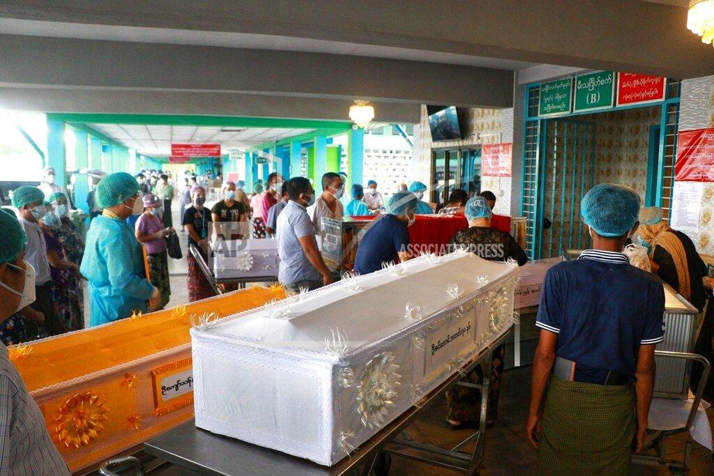 Uncredited In this July 14, 2021, file photo, people wearing face masks wait while caskets with bodies are queued outside a crematorium at the Yay Way cemetery in Yangon, Myanmar. Images of bodies burning in open-air pyres during the peak of the pandemic in India horrified the world in May, but in the last two weeks Myanmar and two other Southeast Asian nations have surpassed India’s peak per capita death rate as a new coronavirus wave tightens its grip on the region. (AP Photo, File)