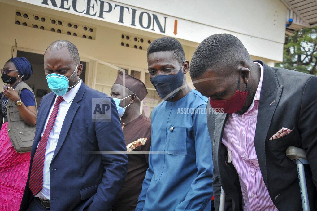 Ronald Kabuubi Ugandan opposition presidential candidate Bobi Wine leaves after a meeting at the Electoral Commission in Kampala, Uganda Wednesday, Dec. 2, 2020. Wine said Wednesday after meeting the head of the country's electoral body that he would resume his campaign after suspending it in protest over police brutality after police shot his car tires and fired rubber bullets that injured his bodyguards and supporters. (AP Photo/Ronald Kabuubi)