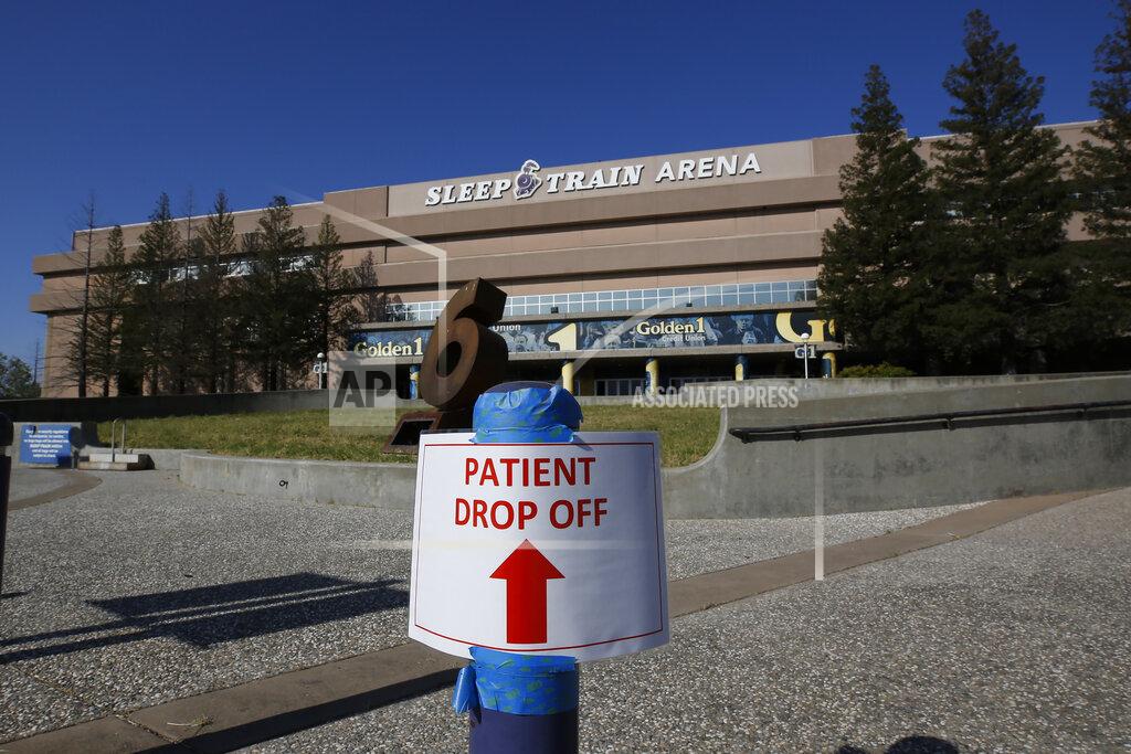 FILE - In this April 18, 2020, file photo, a temporary sign is placed at Sleep Train Arena that had been turned into a 400-bed emergency field hospital in Sacramento, Calif., to help deal with the coronavirus. When California was anticipating a spring surge in coronavirus cases it turned an old NBA arena and practice facility into a field hospital prepared to take hundreds of patients. They were told to expect 30 to 60 patients within the first few days, but only nine arrived over the next 10 weeks. (AP Photo/Rich Pedroncelli, File)