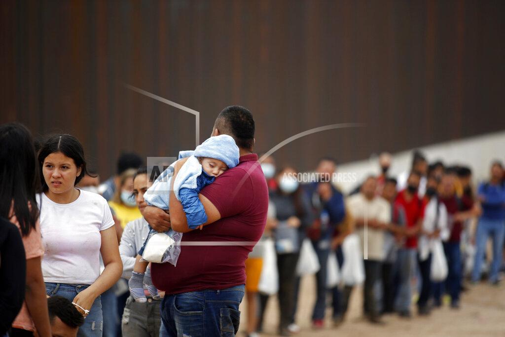 Dario Lopez-Mills Migrants who had crossed the Rio Grande river into the U.S. wait to be processed by Border Patrol agents in Eagle Pass, Texas, Friday, May 20, 2022. The Eagle Pass area has become increasingly a popular crossing corridor for migrants, especially those from outside Mexico and Central America, under Title 42 authority, which expels migrants without a chance to seek asylum on grounds of preventing the spread of COVID-19. A judge was expected to rule on a bid by Louisiana and 23 other states to keep Title 42 in effect before the Biden administration was to end it Monday. (AP Photo/Dario Lopez-Mills)
