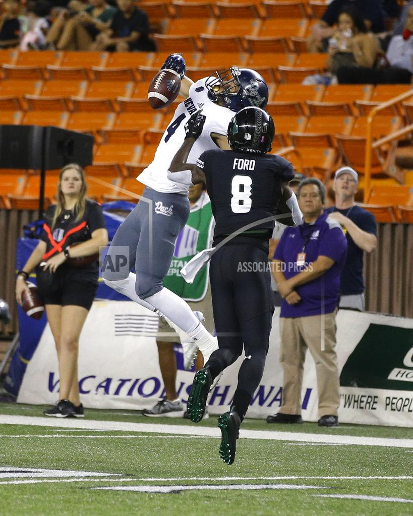 Marco Garcia Nevada wide receiver Elijah Cooks (4) fails to catch as Hawaii defensive back Eugene Ford (8) tries to pressure during the first half of an NCAA college football game Saturday, Oct. 20, 2018, in Honolulu. (AP Photo/Marco Garcia)