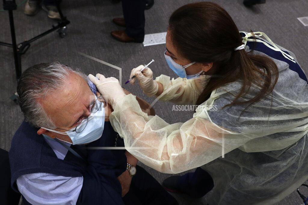 Bilal Hussein A healthcare worker receives Pfizer-BioNTech COVID-19 vaccine during a nationwide vaccination program at the American University Medical Center in Beirut, Lebanon, Sunday, Feb. 14, 2021. (AP Photo/Bilal Hussein)