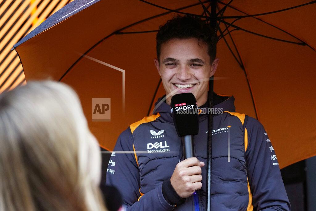 Luca Bruno McLaren driver Lando Norris of Britain speaks with a journalist as he arrives in the paddock at the Dino and Enzo Ferrari racetrack, in Imola, Italy, Thursday, April 21, 2022. Italy's Emila Romagna Formula One Grand Prix will take place on Sunday. (AP Photo/Luca Bruno)