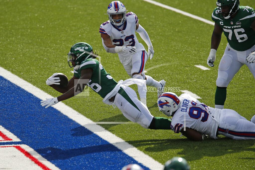 John Munson New York Jets running back Josh Adams (36) falls into the endzone for a touchdown while in the grasp of Buffalo Bills defensive tackle Ed Oliver (91) during the second half of an NFL football game in Orchard Park, N.Y., Sunday, Sept. 13, 2020. The Bills won 27-17. (AP Photo/John Munson)