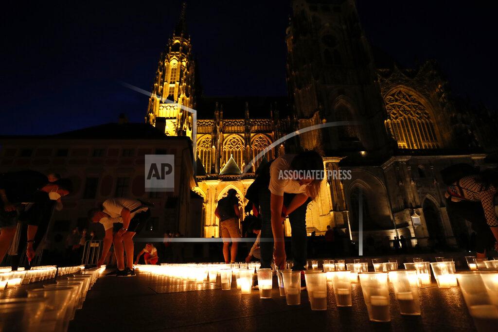 Petr David Josek People light up candles to commemorate victims of the COVD-19 pandemic at the Prague Castle in Prague, Czech Republic, Monday May 10, 2021. The Czech Republic is massively relaxing its coronavirus restrictions as the hard-hit nation pays respect to nearly 30,000 dead. (AP Photo/Petr David Josek)