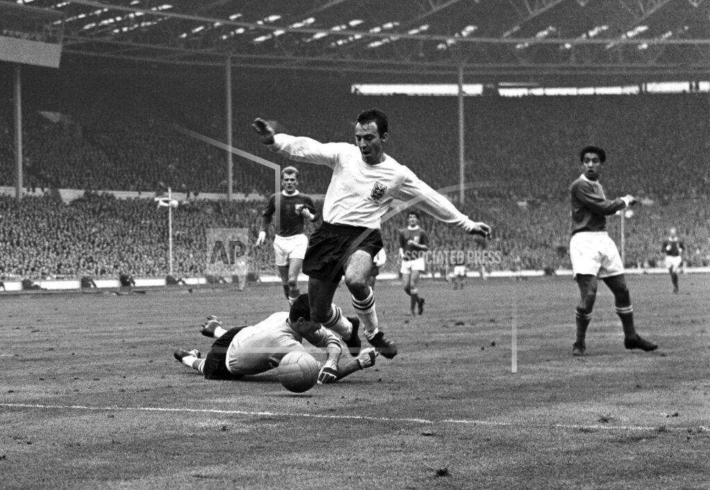 Robert Rider-Rider FILE - In this Oct. 23, 1965 file photo, England inside-right Jimmy Greaves vies for the ball against Yugoslav goalkeeper Milutin Soskic during the second half of the Football Association football match between England and the Rest of the World at Wembley Stadium, London. Jimmy Greaves, one of England’s greatest goal-scorers who was prolific for Tottenham, Chelsea and AC Milan has died. He was 81. With 266 goals in 379 appearances, Greaves was the all-time record scorer for Tottenham, which announced his death on Sunday, Sept. 19, 2021. (AP Photo/Robert Rider-Rider, File)
