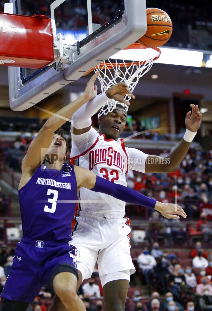 Paul Vernon Ohio State forward E.J. Liddell, right, blocks a shot by Northwestern guard Ty Berry during the first half of an NCAA college basketball game in Columbus, Ohio, Sunday, Jan. 9, 2022. (AP Photo/Paul Vernon)