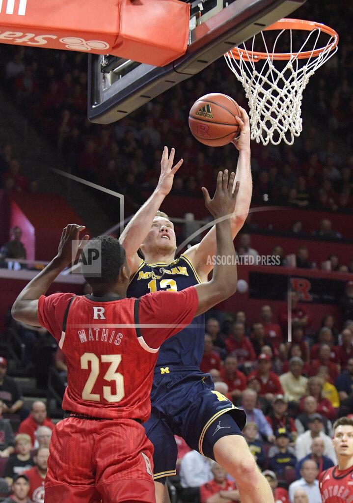Bill Kostroun Michigan forward Ignas Brazdeikis (13) drives to the basket as Rutgers guard Montez Mathis (23) defends during the first half of an NCAA college basketball game Tuesday, Feb. 5, 2019, in Piscataway, N.J. (AP Photo/Bill Kostroun)